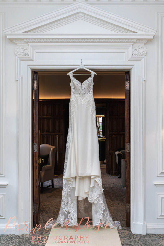 Photo of a wedding dress hanging in a doorway at Horwood House in Milton Keynes