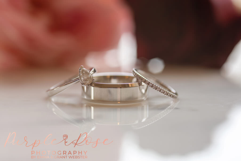 Photo of a couples wedding rings and engagement rings stacked together in Milton Keynes