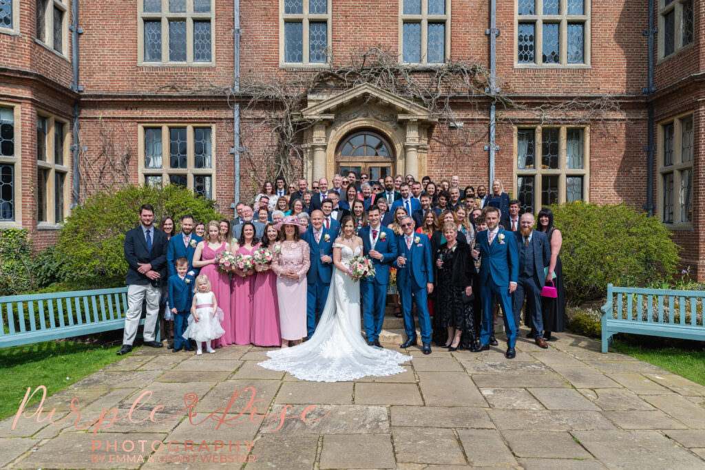 Photo of bride , groom and all their wedding guests outside their wedding venue in Milton Keynes