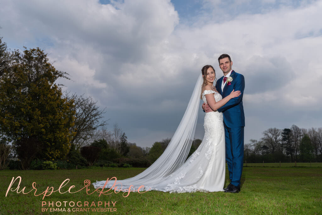 Photo of bride and groom standing in the gardens of their wedding venue in Milton Keynes