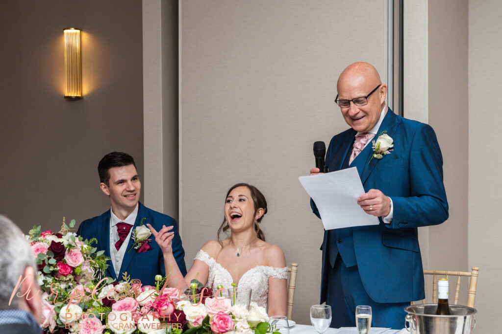 Photo of bride and groom laughing during their wedding reception in Milton Keynes
