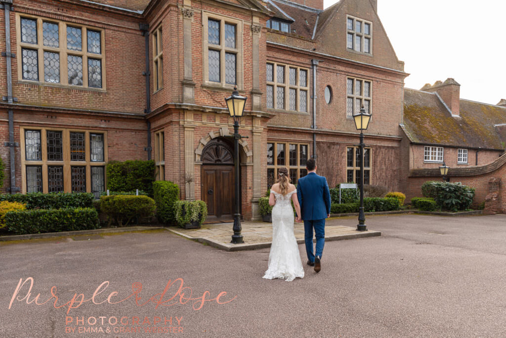 Photo of a bride and groom walking to theri wedding venue in Milton Keynes