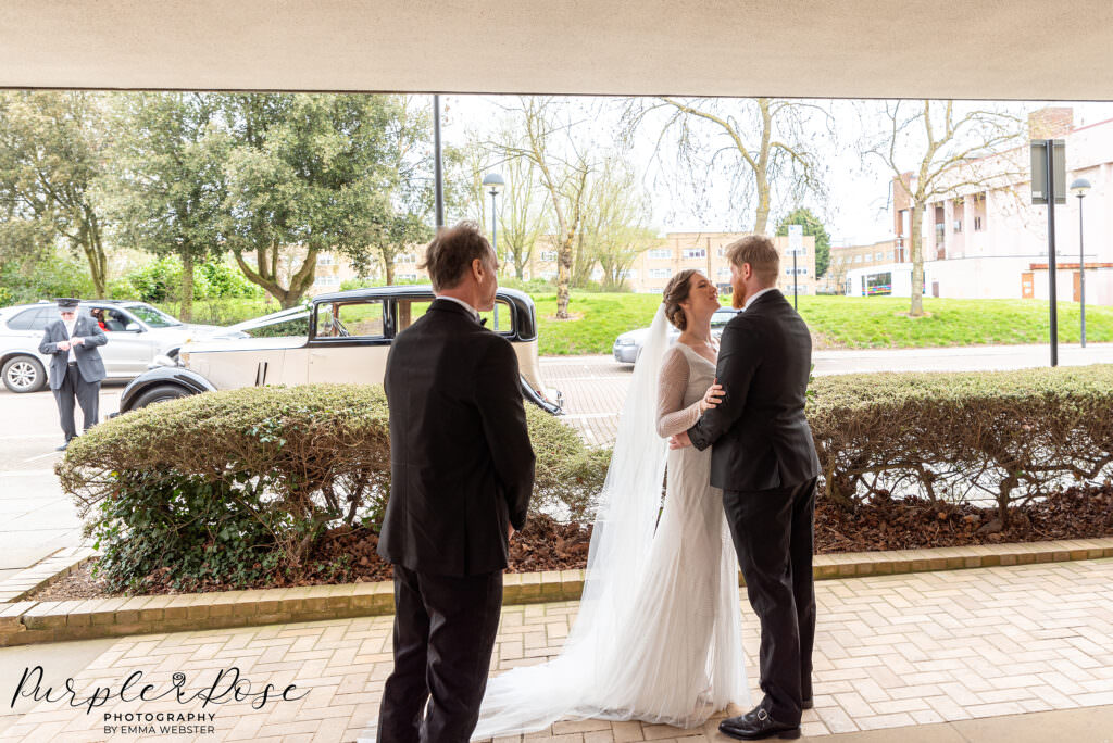 Bride embracing her groom outside Milton Keynes Registry Office