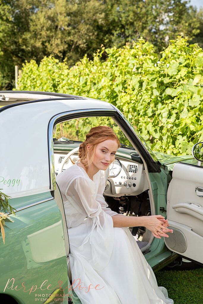 Bride leaning out of car