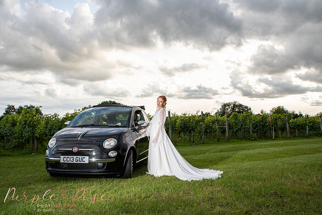 Bride stood by car