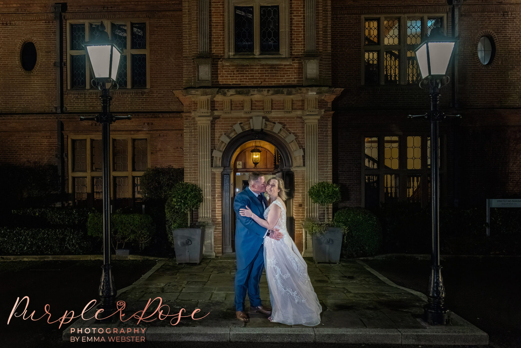 Bride and groom at night in front of their wedding venue