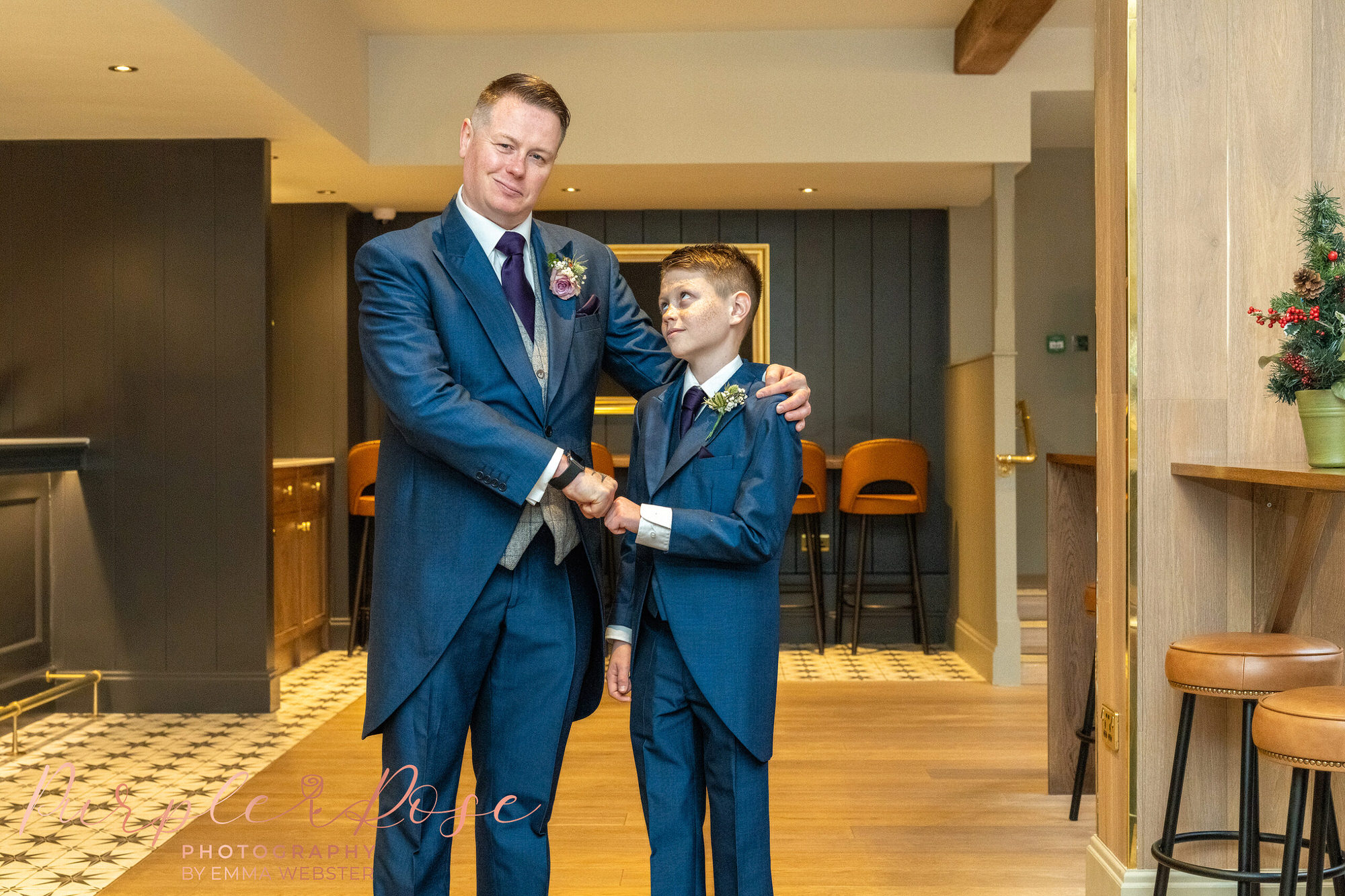Groom fist bumping a page boy