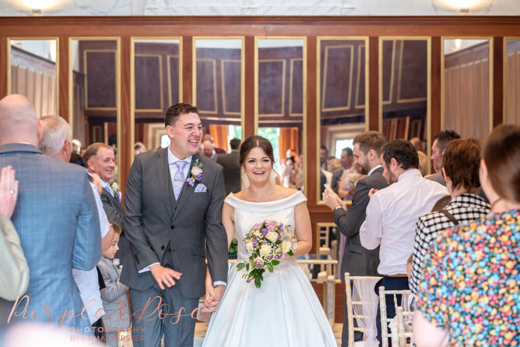 Bride and groom leaving their wedding ceremony