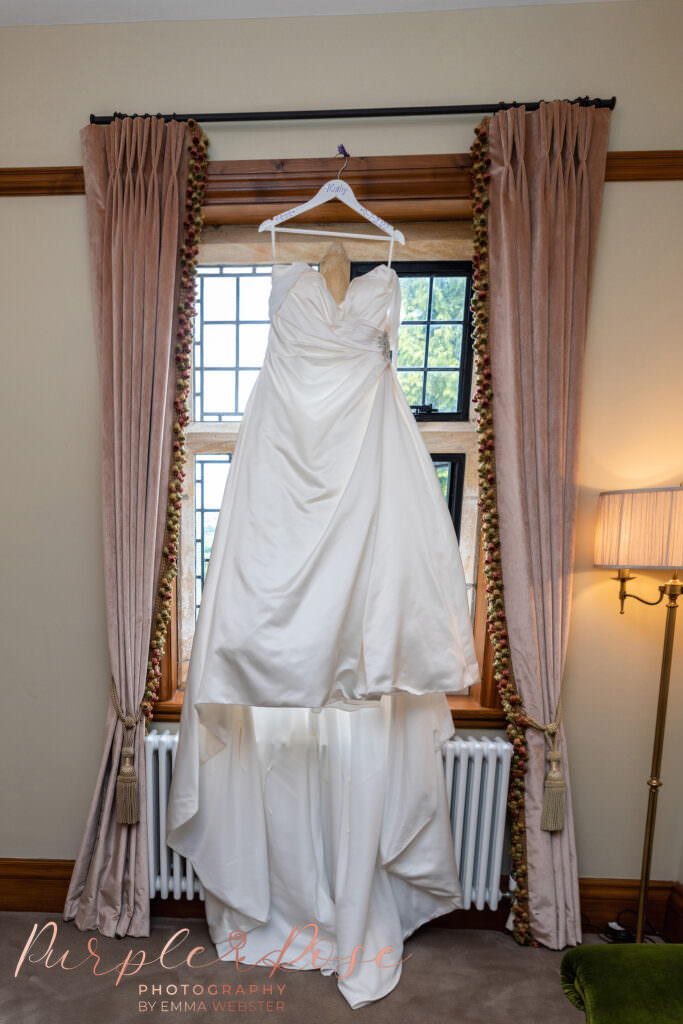 Bridal gown hanging in a window