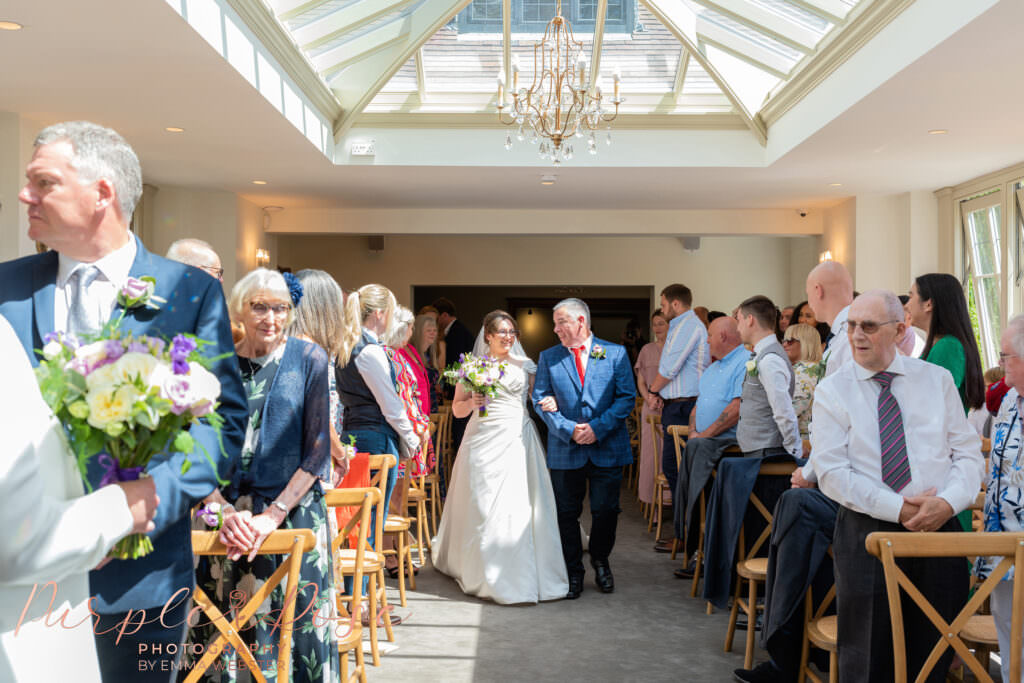 Bride and her father walking into wedding ceremony