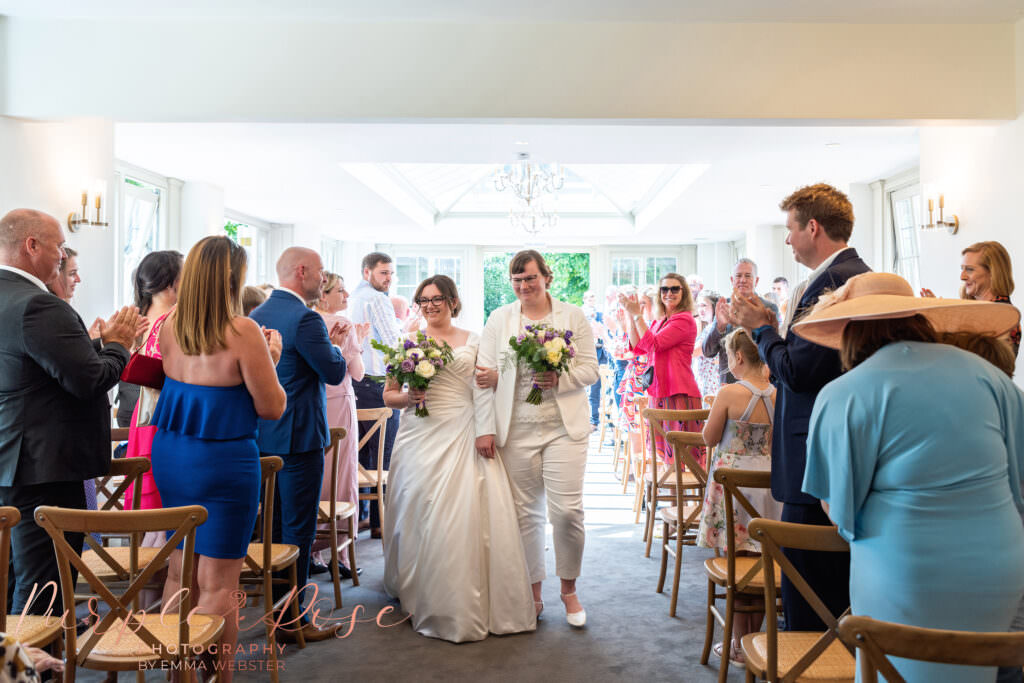 Brides leaving their wedding ceremony