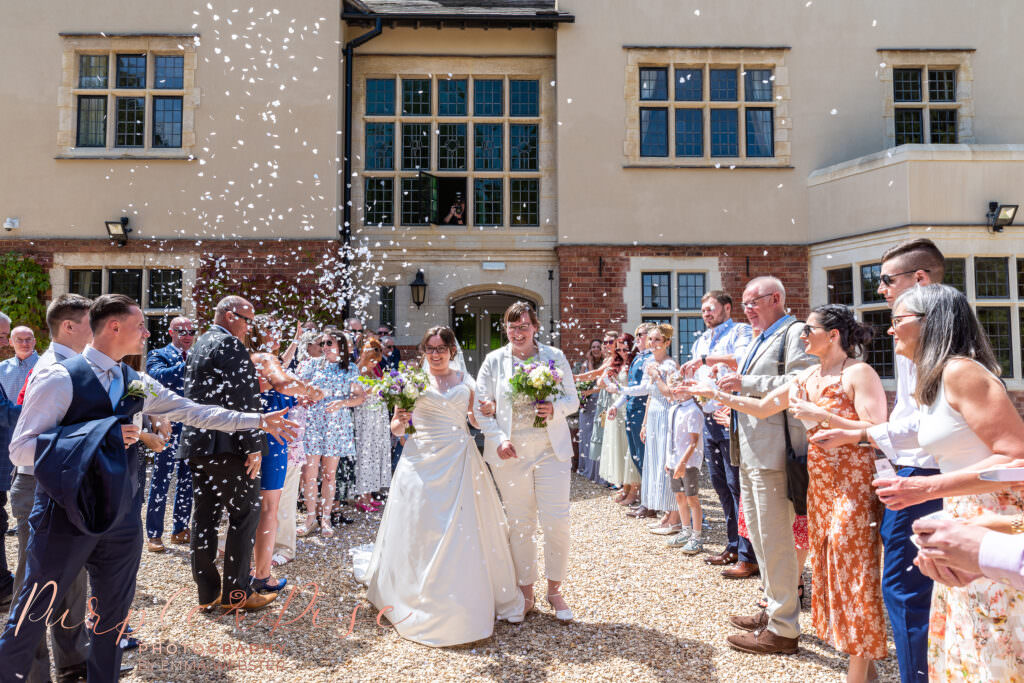 Brides being showered in confetti