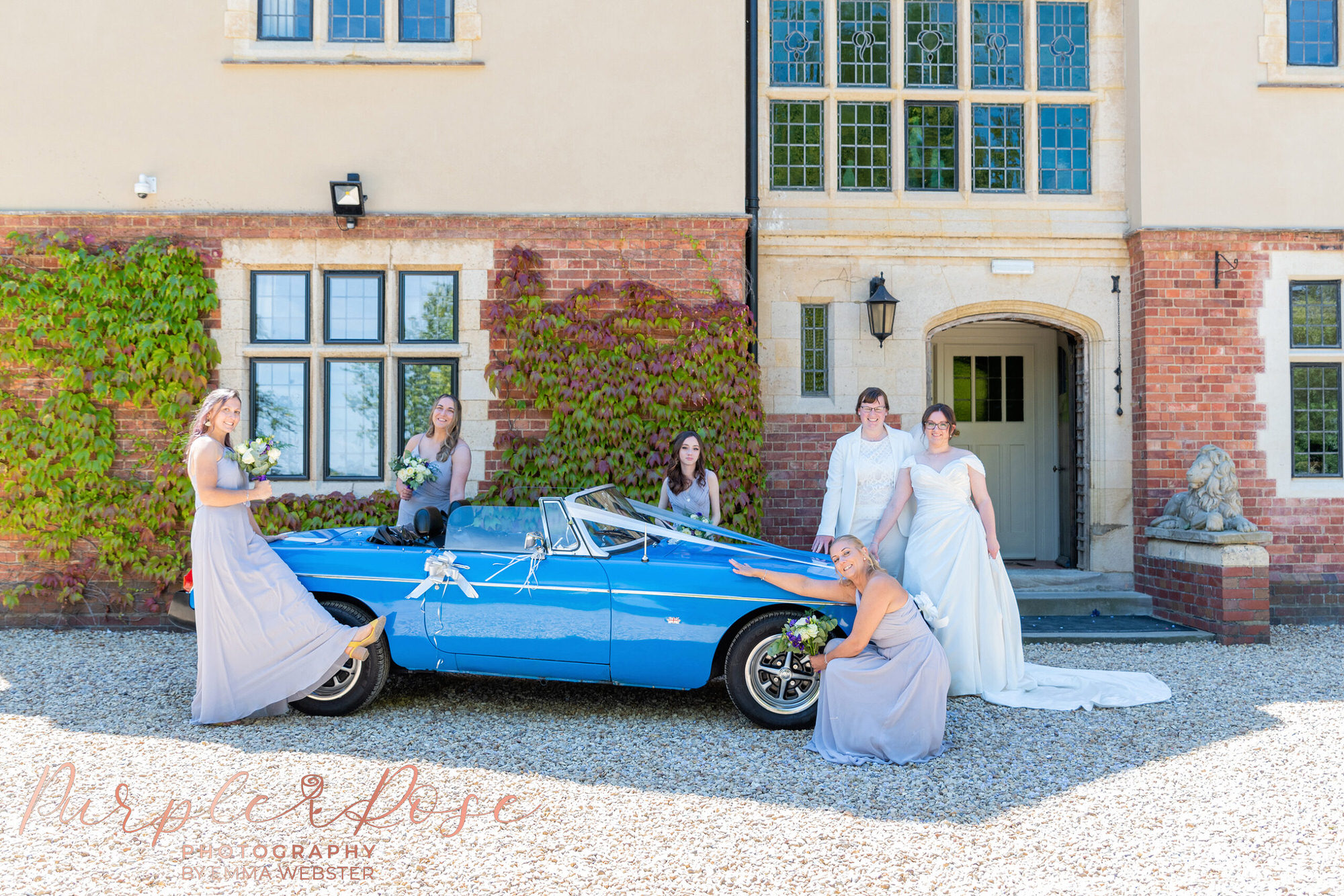 Brides and bridesmaid with wedding car