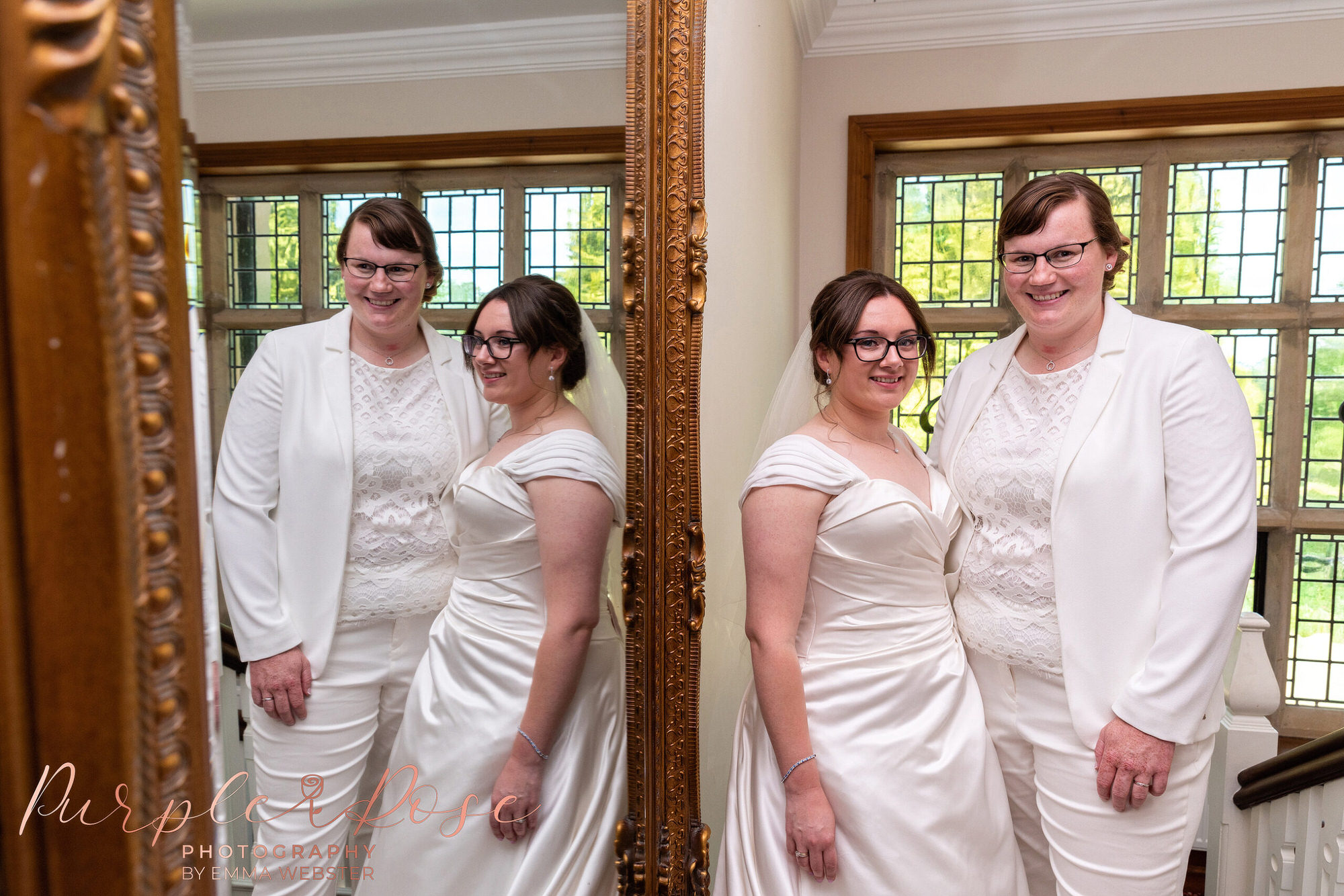 Brides by mirror in wedding venue