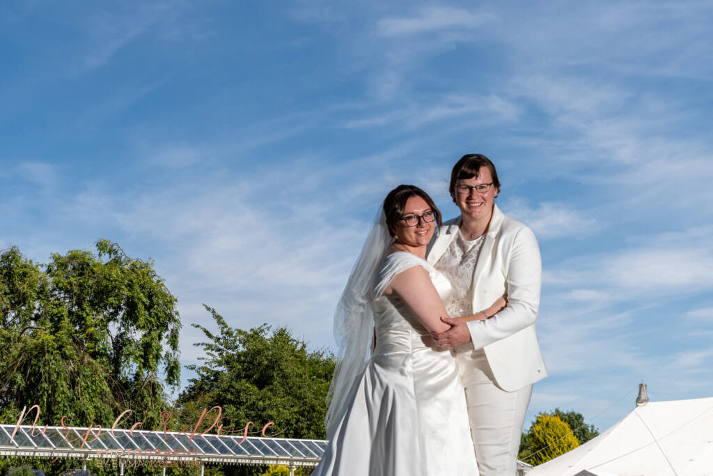 Brides in front of wispy clouds