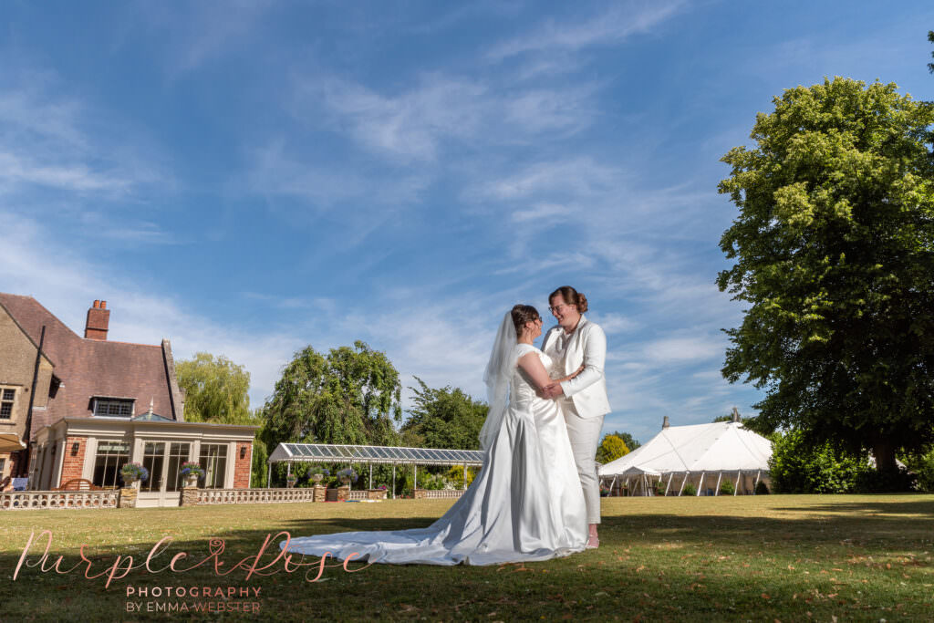 Brides in the garden of their wedding venue