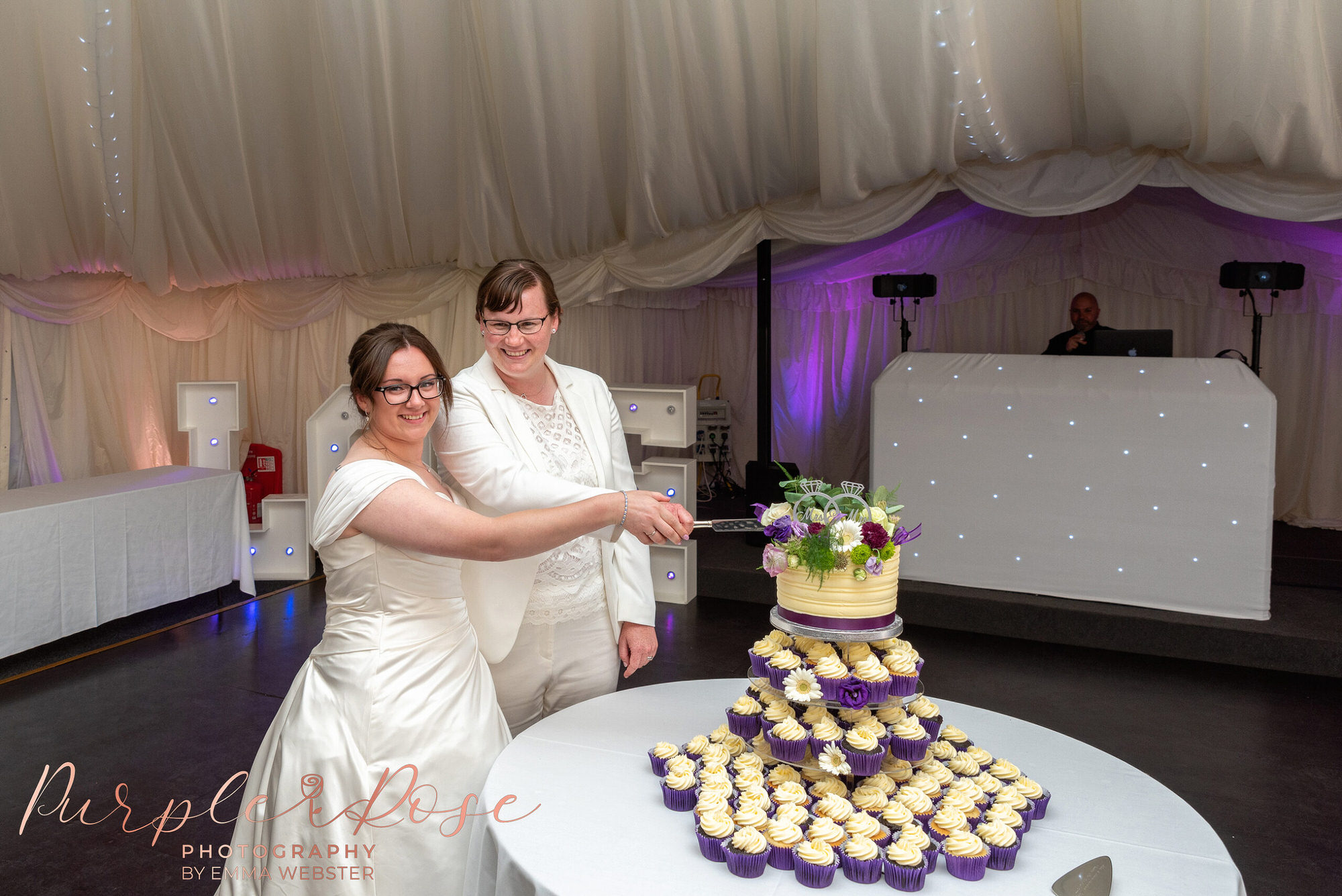 Brides cutting their wedding cake
