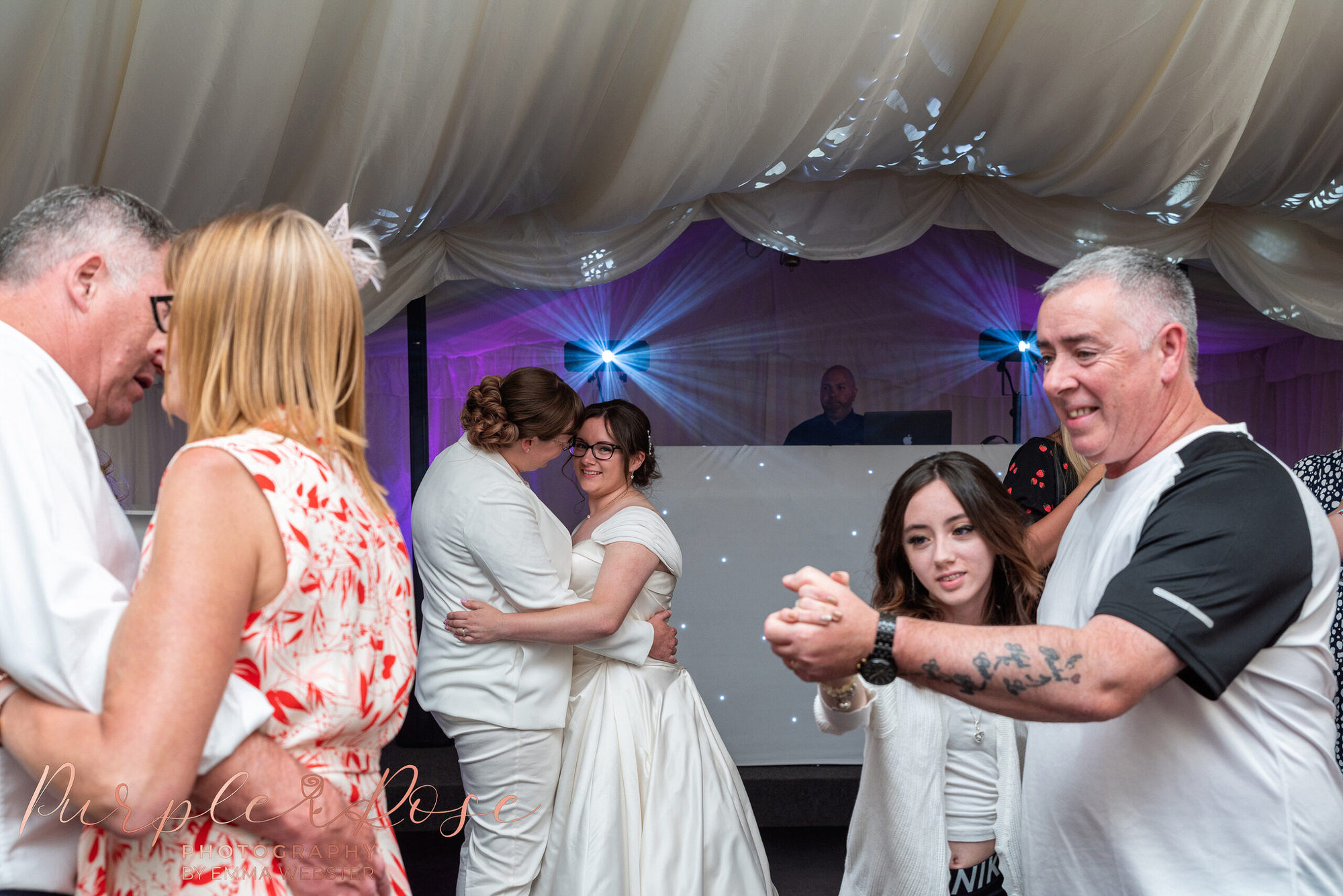 Brides and wedding guests dancing