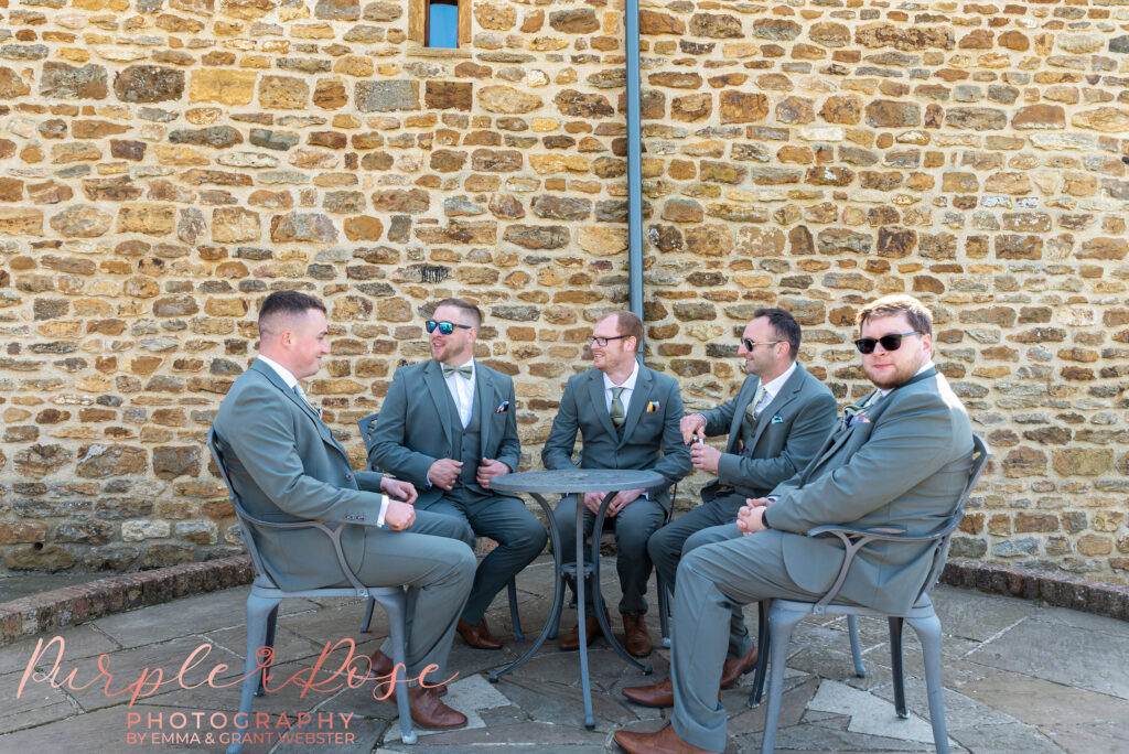 Photo of groom and his groomsmen relaxing in the grounds of Dodford manor ahead of the wedding ceremony