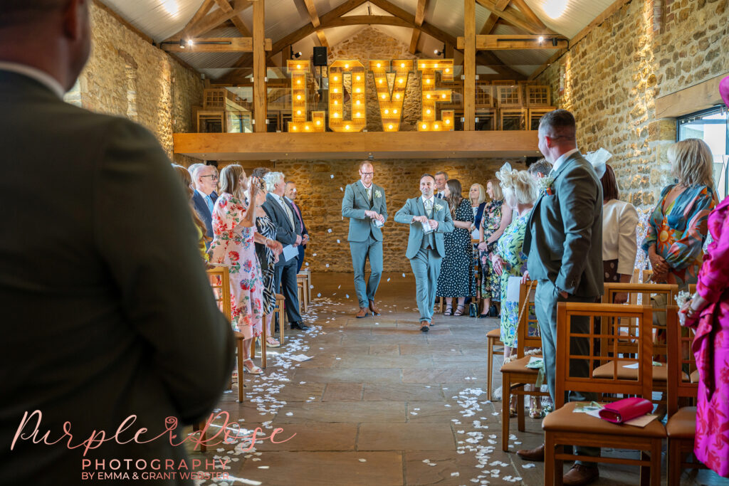 Groomsmen, acting as flower men as they threw flowers.