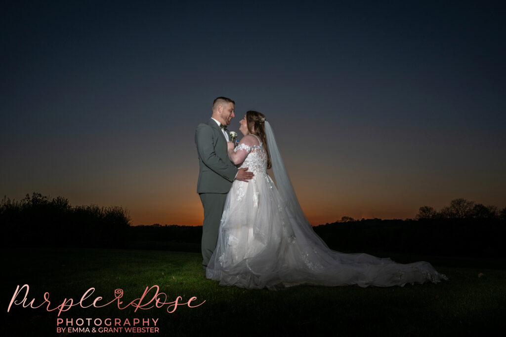 Photo of a bride and groom enjoying the sunset at Dodford Manor