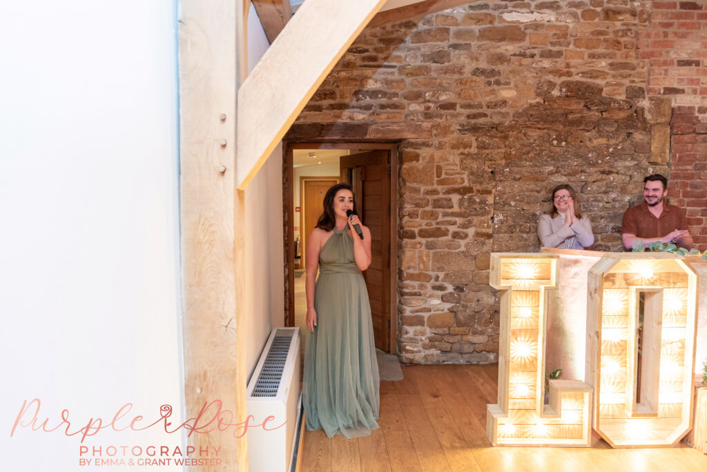 Bridesmaid singing at a wedding held at Dodford Manor in Northampton