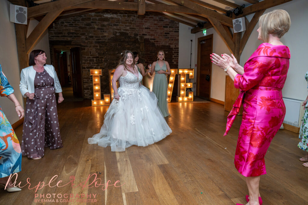 Bride dancing on her wedding day at Dodford Manor in Northampton