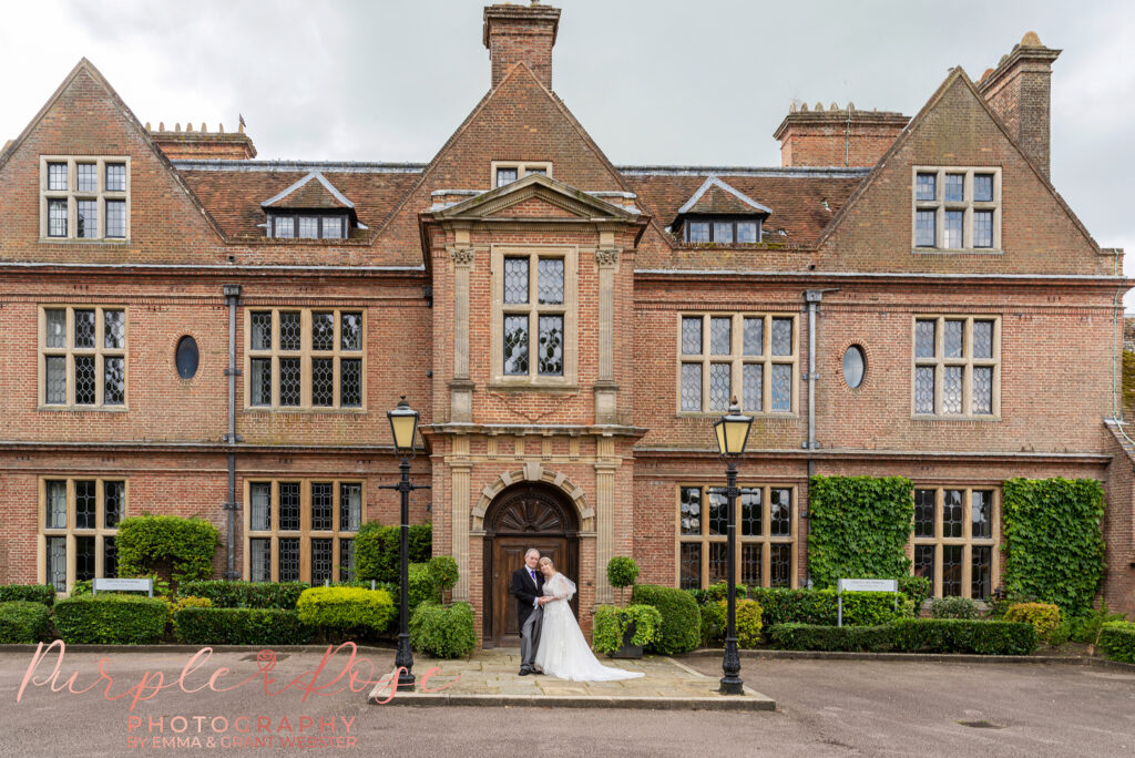 Bride and groom stood in front of Horwood House on their wedding day in Milton Keynes