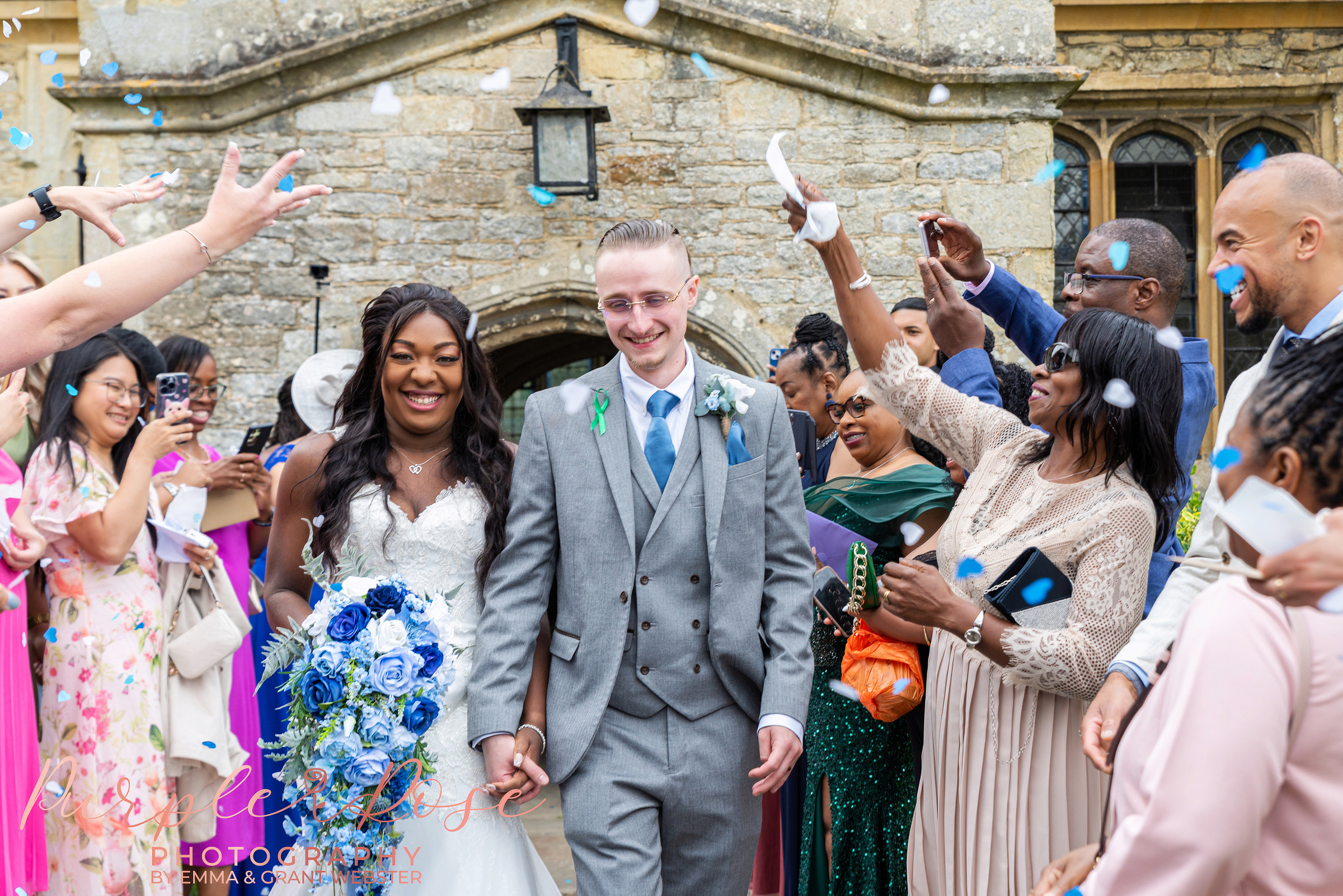 Bride and groom laughing as they leave the church on their wedding day in Bicester