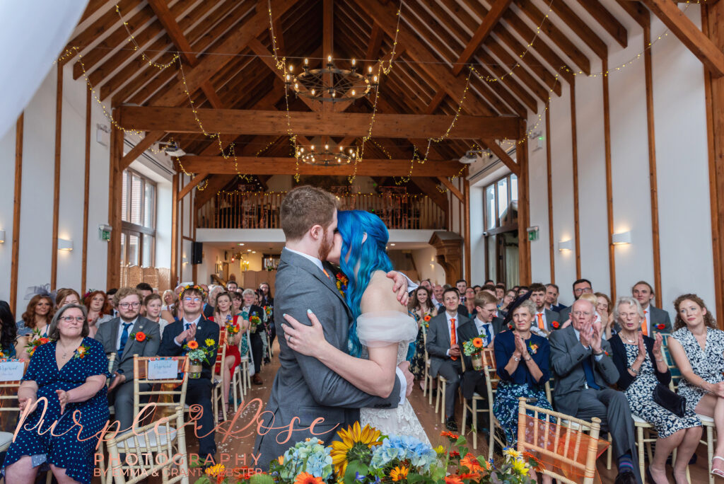 Photo of bride and groom kissin gduring ther wedding ceremony in Milton Keynes