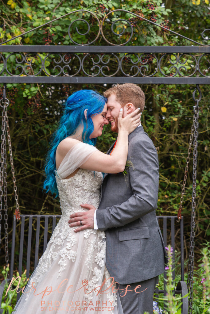 Photo of a bride and groom in fornt of a swing on their wedding day in Milton Keynes