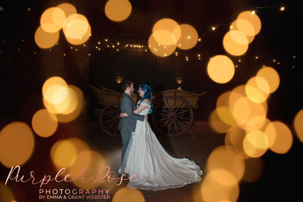 Nigh time photo of a bride and groom surrounded by fairy lights on their wedding day in Milton Keynes