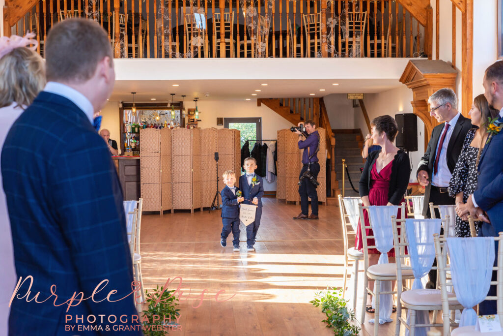 Photo of page boys walking into the wedding ceremony in Milton Keynes