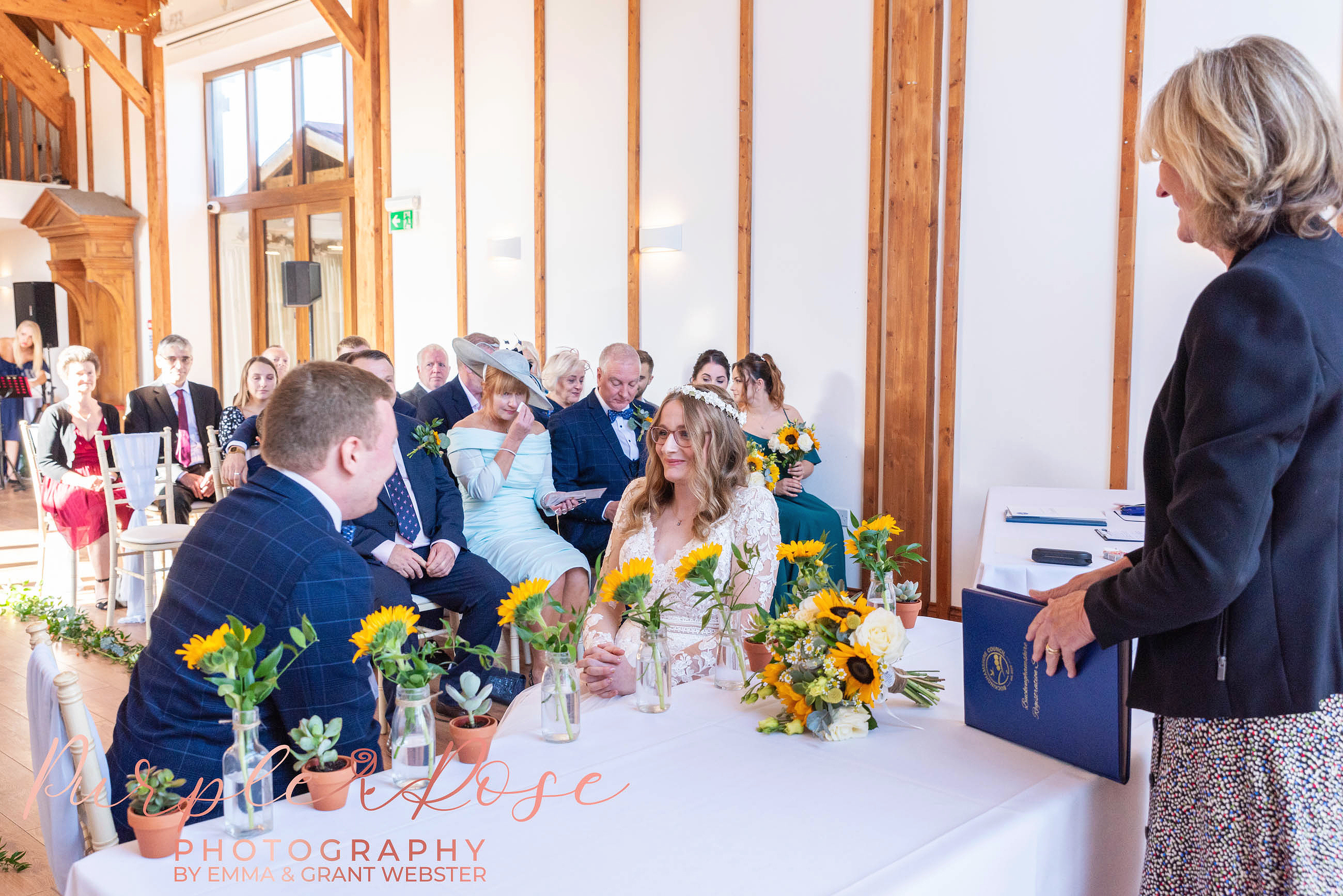 Photo of a bride and groom sat duing their wedding ceremony in Milton Keynes