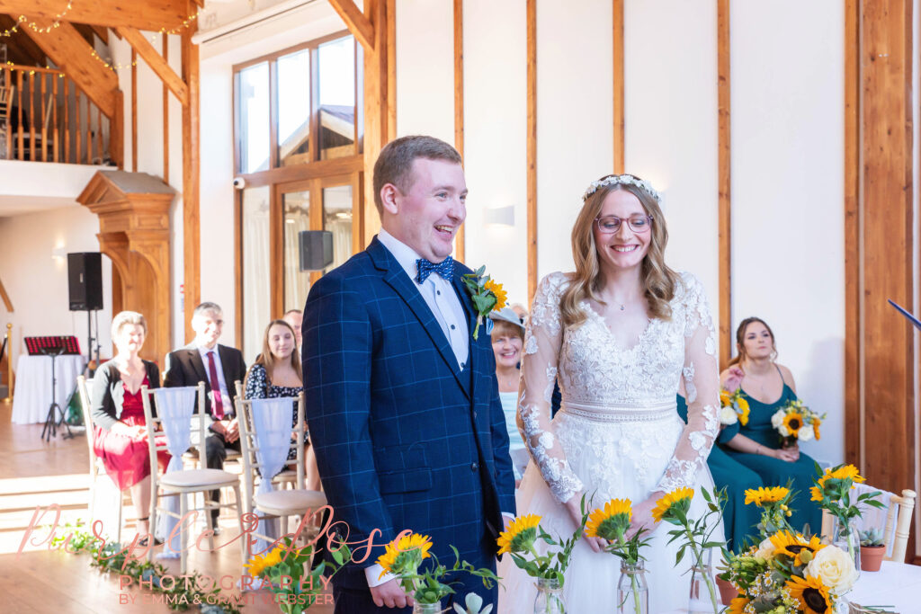 Photo of a bride and groom laughing during their wedding ceremony in Milton Keynes