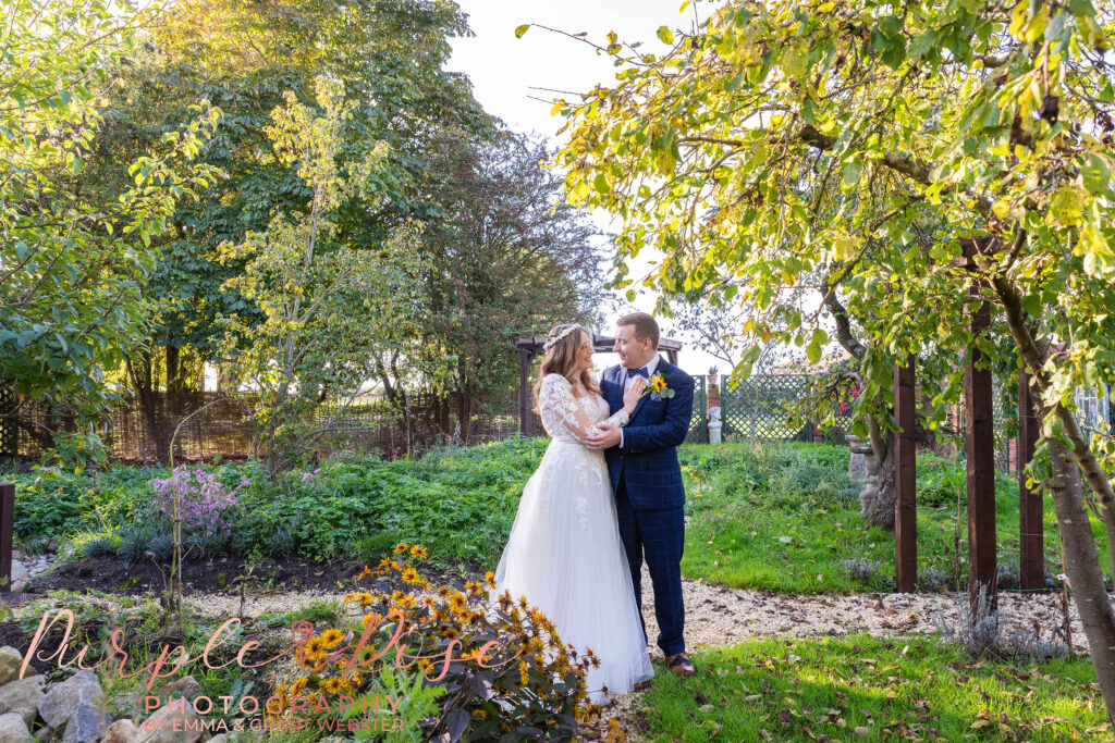 Photo of a bride and groom stood in a garden on their wedding day in Milton Keynes