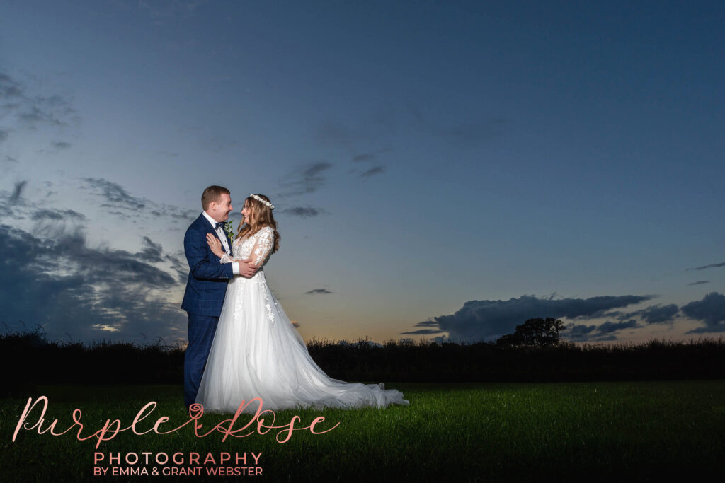 Photo of a bride and groom in fornt of a sunset on their wedding day in Milton Keynes