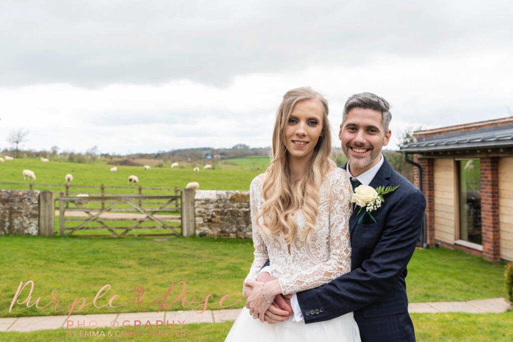 Photo of groom hugging his bride outside on their wedding day in Milton Keynes