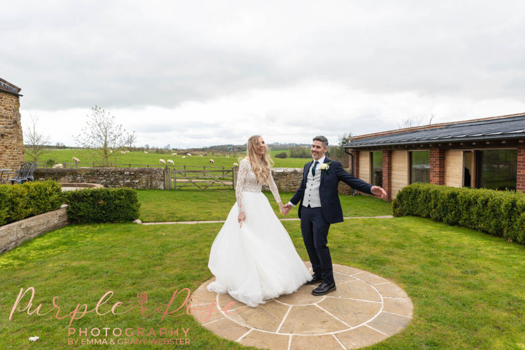 Photo of bride and groom dancing outside their wedding venue in Milton Keynes