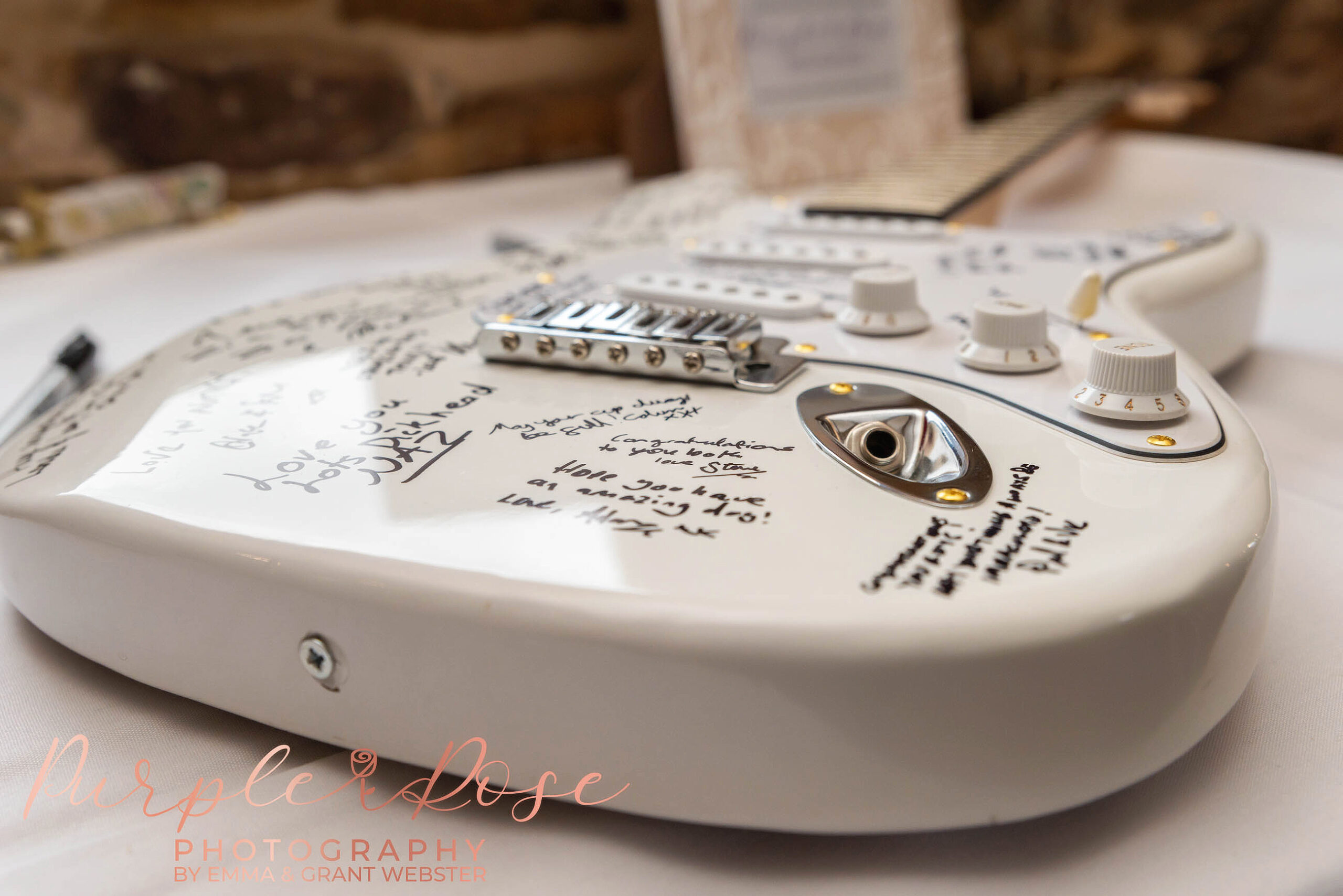 Photo of a white guitar used as a signature book at a wedding in Milton Keynes