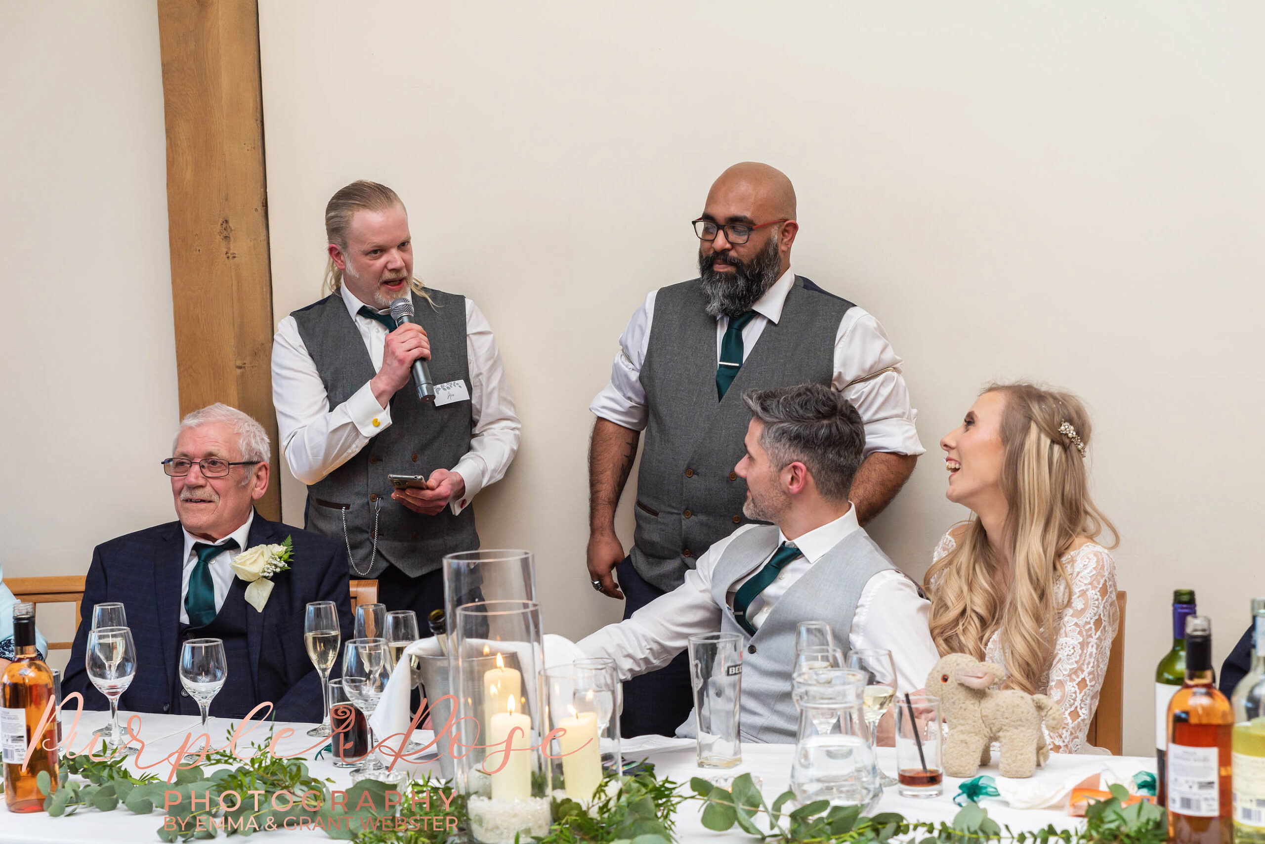 Photo of a bride and groom laughing during the speeches at their wedding in Milton Keynes