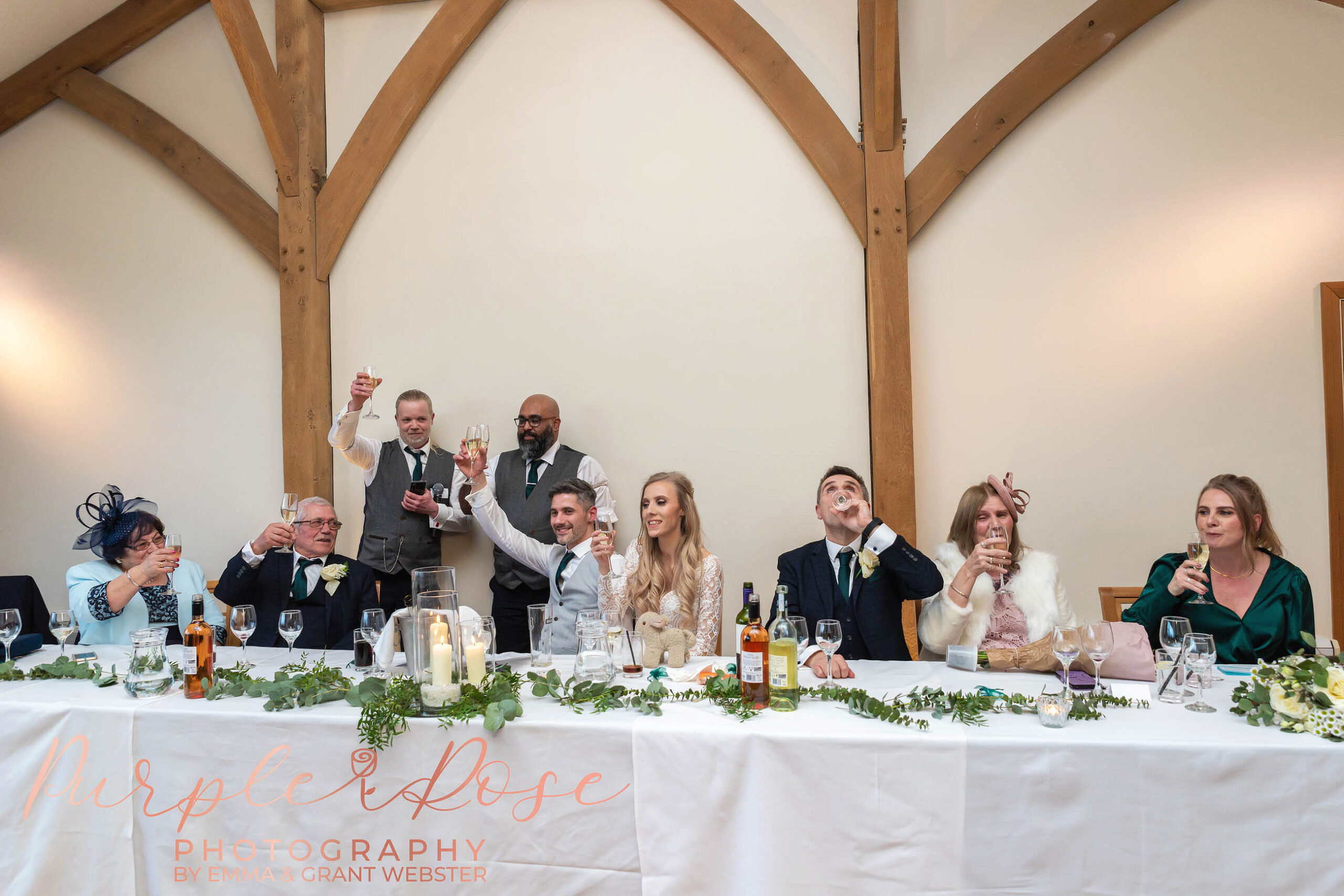 Photo of drinks being raised during the speeches at a wedding in MIlton Keynes