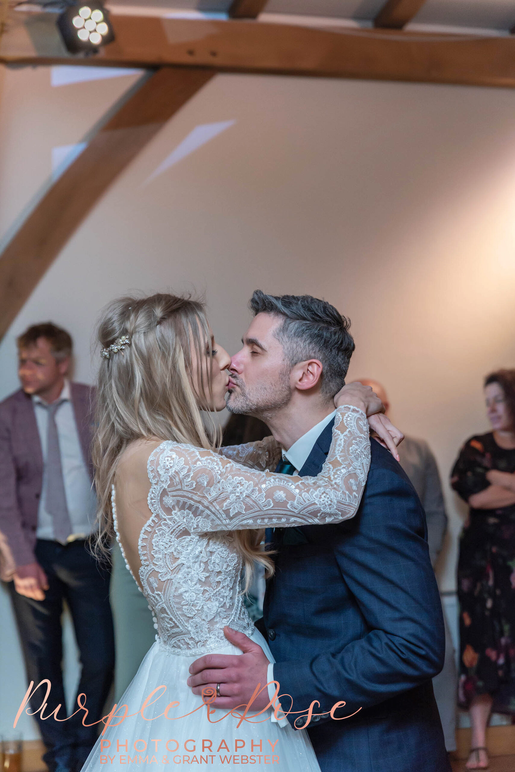 Photo of a bride and groom kissing on the dancefloor during their first dance on their wedding day in Milton Keynes