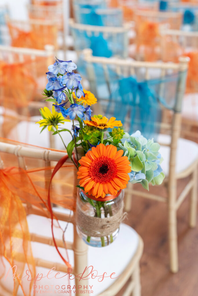 Photo of flowers tied to a chair at a wedding in Buckinghamshire