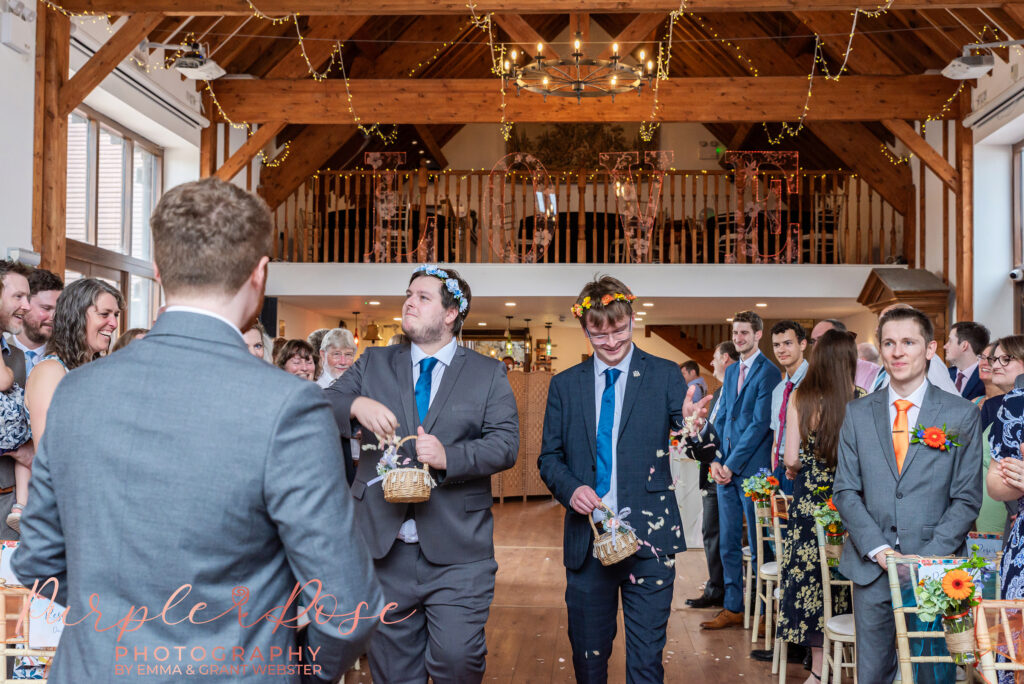 Photo of two flower men throwing petals at a wedding in Buckinghamshire