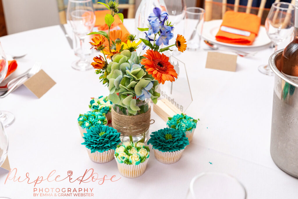 Photo of flowers and cupcakes on a table at a wedding in Milton Keynes