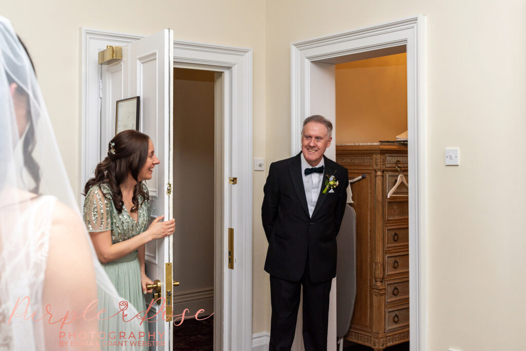 Photo of a father seeing his daughter in her wedding dress for the first time on her wedding day in Northampton