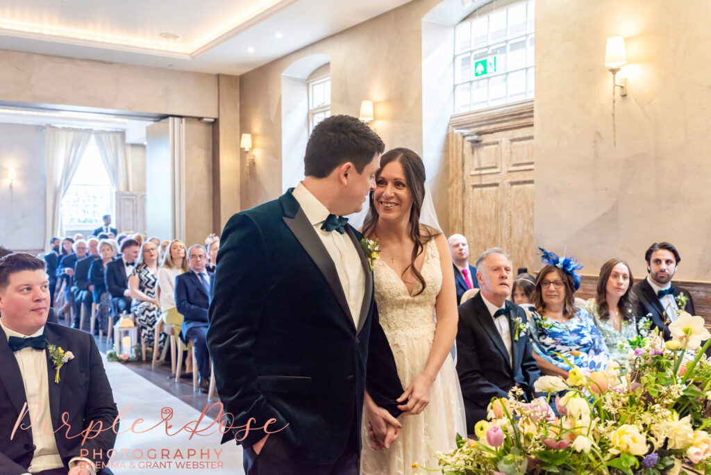 Photo of a bride and groom smiling during their wedding ceremony in Northampton