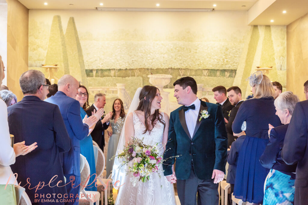 Photo of a bride and groom as they leave their wedding ceremony in Northampton