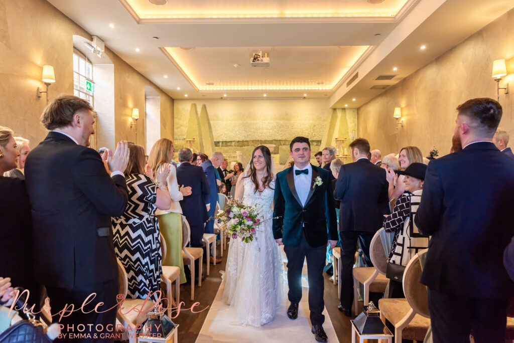 Photo of a bride and groom as they leave their wedding ceremony in Northampton